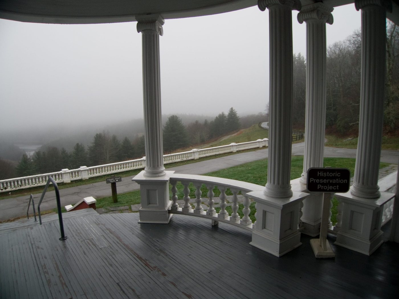 A porch’s columns, the valley in fog beyond